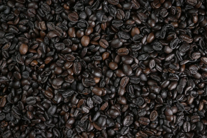 Roasted coffee beans fill the entire frame.